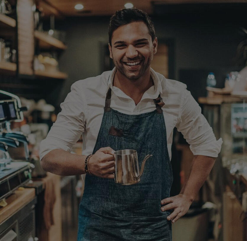 A barista content with the new inflow of customers An entrepreneur, a barista of a small café or a bar, happy client of ApareixIA